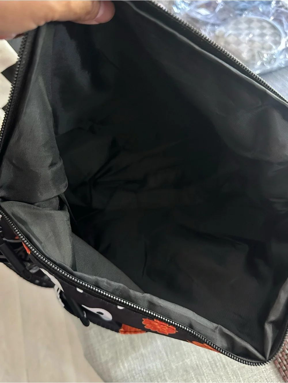 Halloween-themed crossbody bag featuring a skull and marigold print